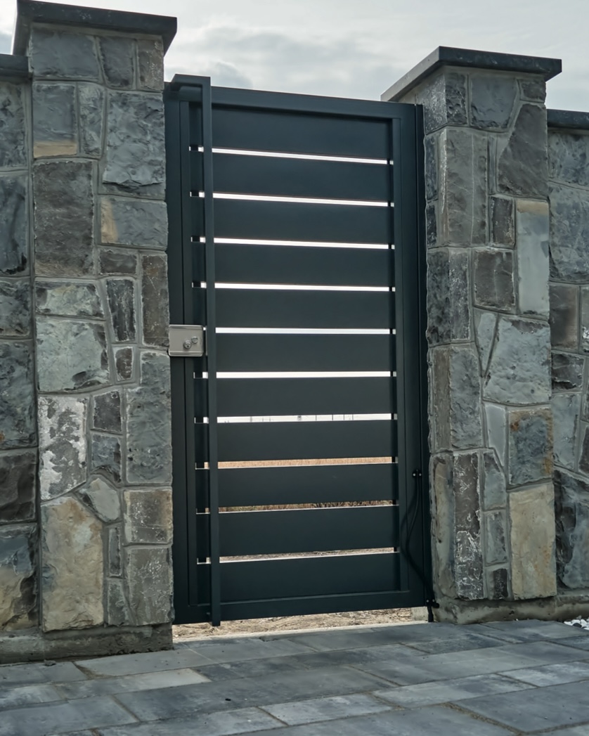 Slatted gate with stone columns